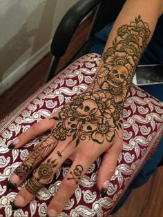 a woman's hand with henna tattoos on it