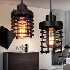 two light fixtures hanging from the ceiling in a room with furniture and decor on it