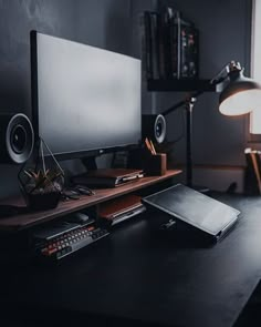 a desk with a laptop and speakers on it