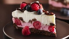 a piece of cheesecake with raspberries and chocolate