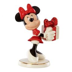 a minnie mouse figurine holding a present