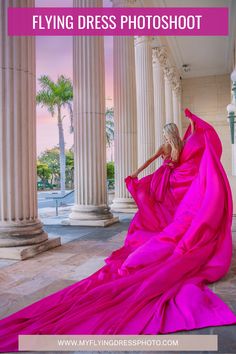 a woman in a pink dress sitting on the ground with columns and palm trees behind her