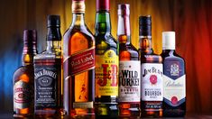 an assortment of alcohol bottles lined up on a table