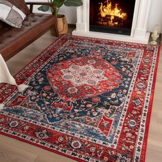 a living room with a fire place in the fireplace and rugs on the floor