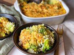 two bowls filled with broccoli and rice on top of a white table cloth