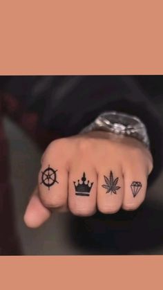 a person's fingers with tattoos on them