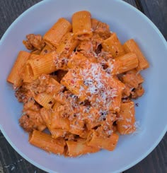 a white bowl filled with pasta and sauce