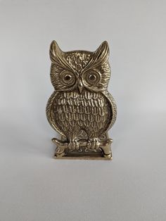 an owl figurine sitting on top of a table