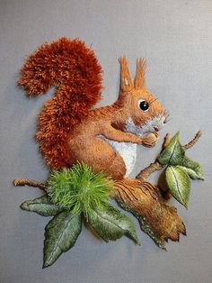 an image of a squirrel on a tree branch with leaves and acorns around it