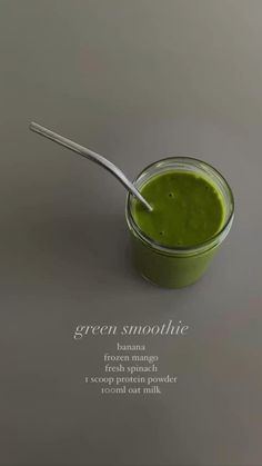 green smoothie in a small glass jar with a spoon on the side that says, green smoothie