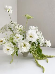 white flowers in a vase on a table