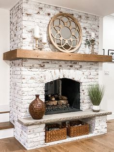 a white brick fireplace with a mirror above it and baskets on the mantel below