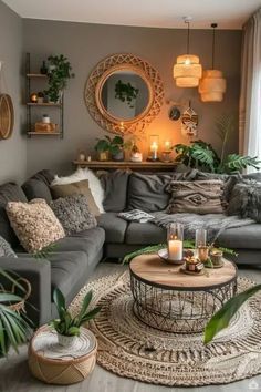 a living room filled with lots of furniture and plants on top of a wooden floor