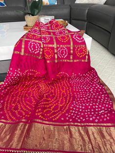 Beautiful Silk Saree with Bandhani print . Suitable for every occasion.  Saree Material ------Art Silk  Color ---------Rani bright pink  Saree length -------5.50 m  Blouse --------unstitched  Blouse meters --------0.9 m  Work of sareee------  Bandhani print with Zari Pallu n Gota Border.  🥰 Fall and piko already done .  🥰 Ready to wear .  �🥰 Dry clean wash as it is Handmade Bandhani saree ( Original) , not machine printed.  Occasions: Wedding Wear, Party Wear, Festive Wear, Durga Puja, Indian Haldi Wear, Saree Material, Bandhani Print, Bandhani Saree, Durga Puja, Festive Wear, Zari Work, Pink Saree, Wedding Wear