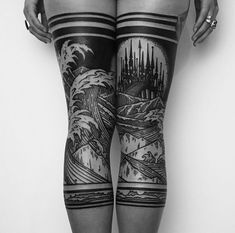 a woman's legs with black and white tattoos on her thighs, both showing their butts