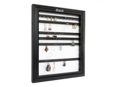 a wall mounted jewelry rack with earrings on it