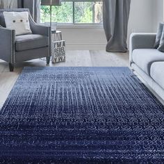 a living room with a blue rug on the floor