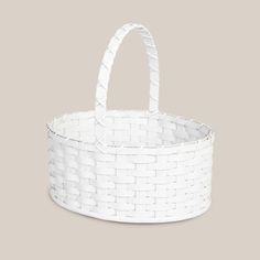 a white basket with handles on a gray background