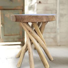 a wooden table sitting on top of a white floor