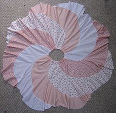 a pink and white frilly on the floor in front of a carpeted area