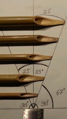 four woodworking tools are arranged on top of a drawing