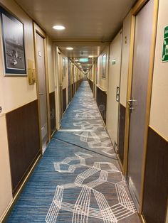 an empty hallway with blue carpet and pictures on the walls royalty images, stock photos