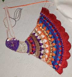 a close up of a piece of cloth on a table with beads and other items