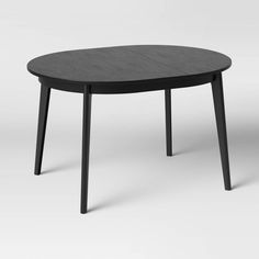 a black table sitting on top of a white floor