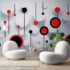 a living room with white and red furniture in front of a modern wallpaper design