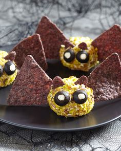 some food is on a plate with chocolate chips and crackers in the shape of bats