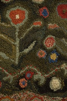 an area rug with many different colored flowers on it's surface, including red, blue and green colors