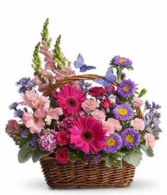 a basket filled with lots of colorful flowers