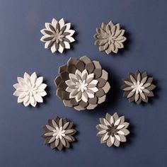 paper flowers are arranged on a blue surface