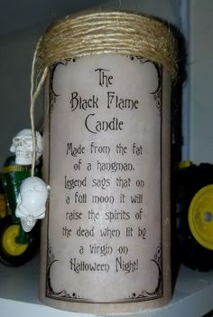 a candle with a poem on it sitting on a shelf