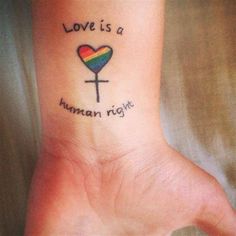 a woman's foot with a heart and cross tattoo on the ankle that says love is a human right