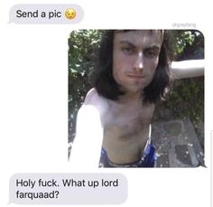 a man with long hair and no shirt is looking at the camera while texting