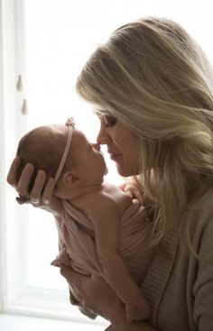 a woman holding a baby in her arms