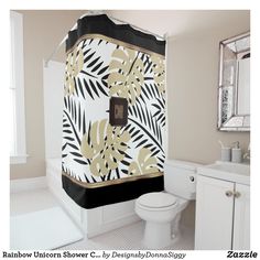 a bathroom with a black and white shower curtain next to a toilet under a mirror