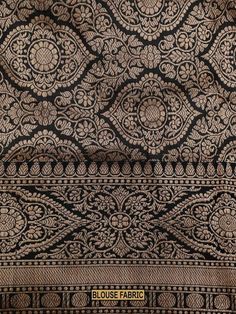 an old black and gold cloth with intricate designs