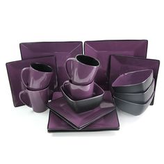 a purple and black dinnerware set on a white background