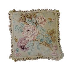 an embroidered pillow with flowers on it