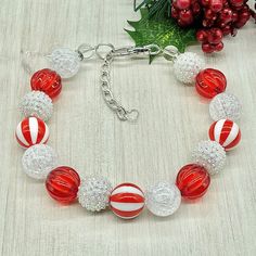 a red and white beaded bracelet on a table