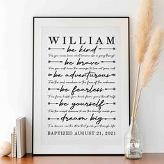 a framed print with the words william and elizabeth on it, next to some books