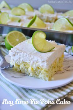 a slice of key lime pie poke cake on a plate next to a tray of lemons