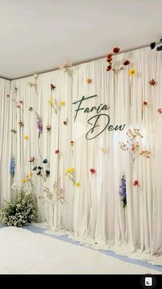 a room with flowers on the wall and curtains behind it that say faraway dew