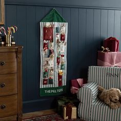 a teddy bear sitting on top of a chair in front of christmas presents and gifts