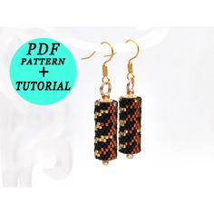 a pair of earrings that are made out of woven material and gold plated wire