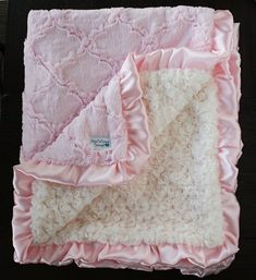 a baby blanket with pink ruffles on it and a price label for the product