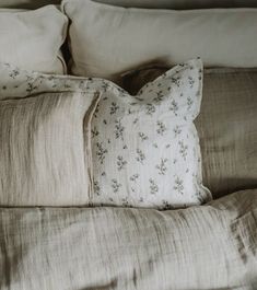 two pillows on top of a bed next to each other