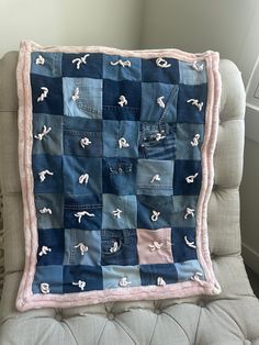 a blue and pink patchwork quilt on a chair with the back turned to look like it is made out of old jeans